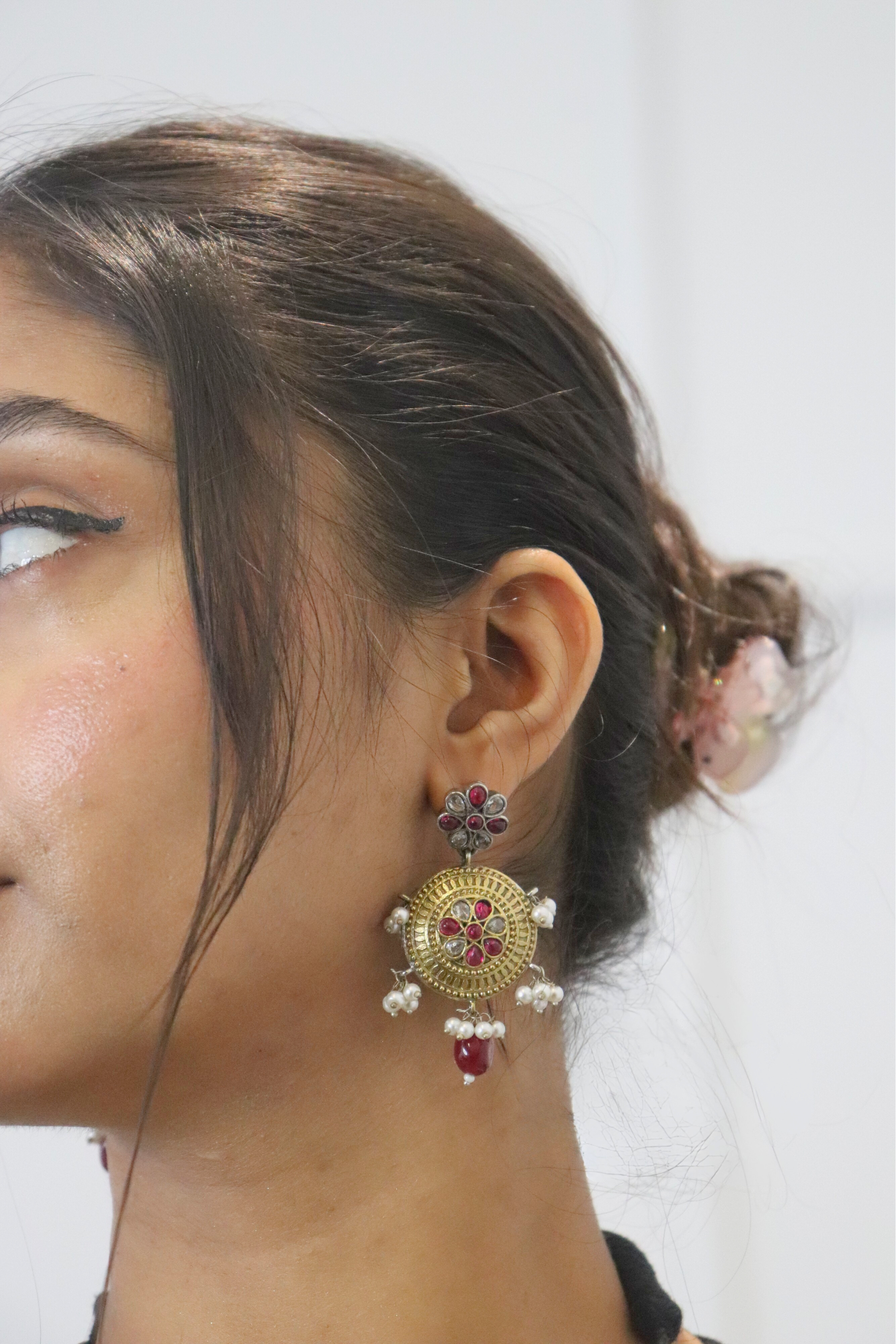 Close-up of a person wearing a decorative earring