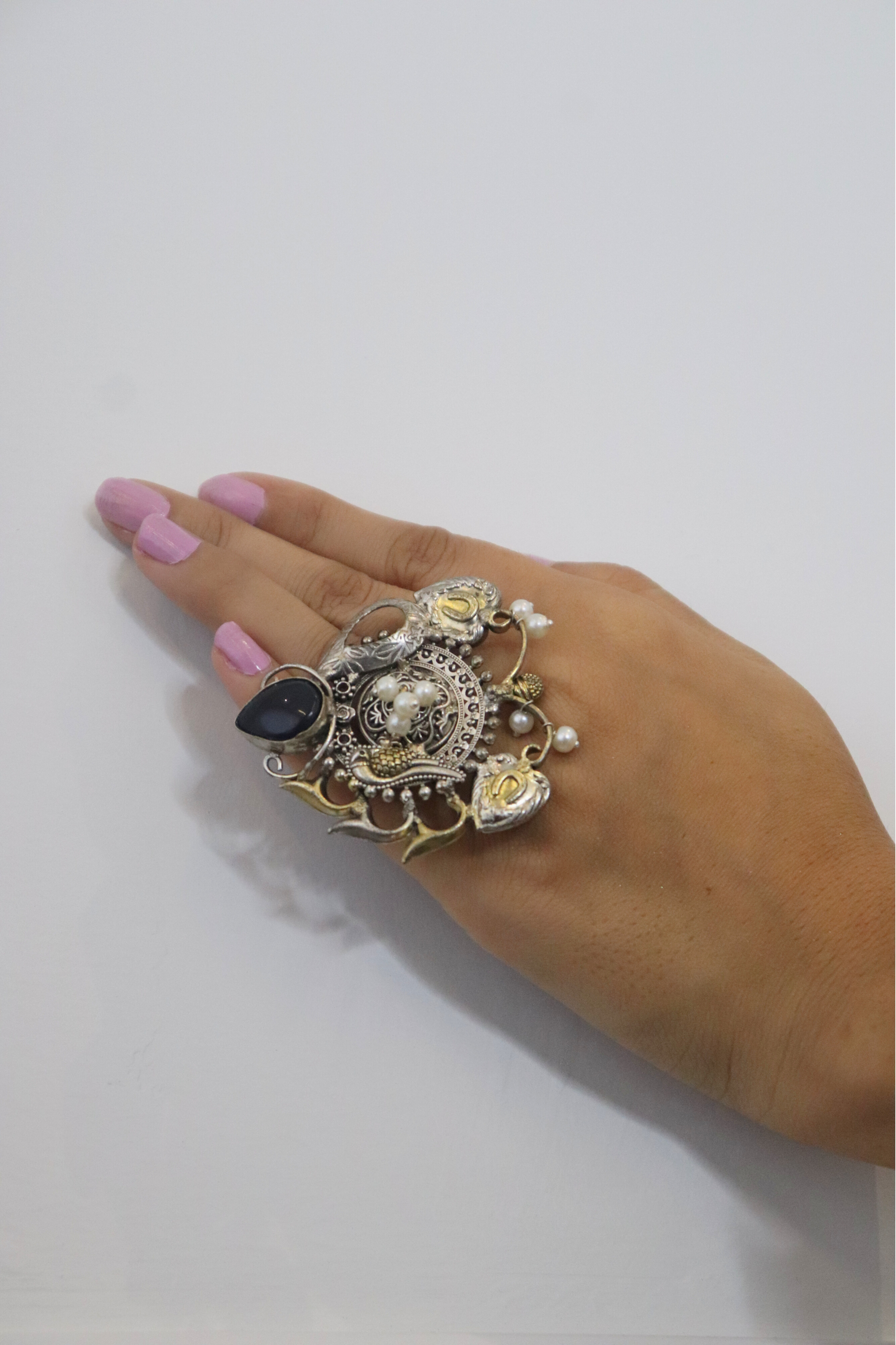 Decorative ring with black gemstone on a hand