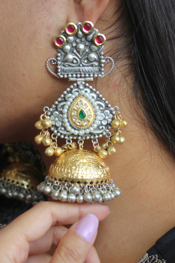 Ornate gold and silver earrings with red and green stones