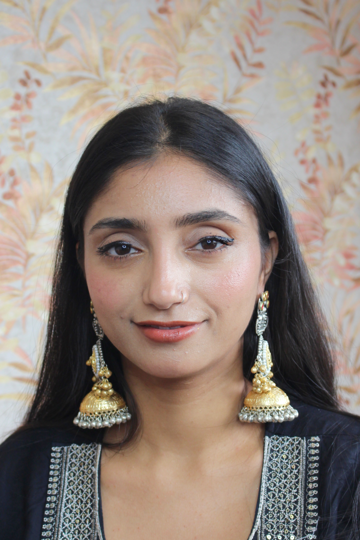 Woman wearing gold earrings