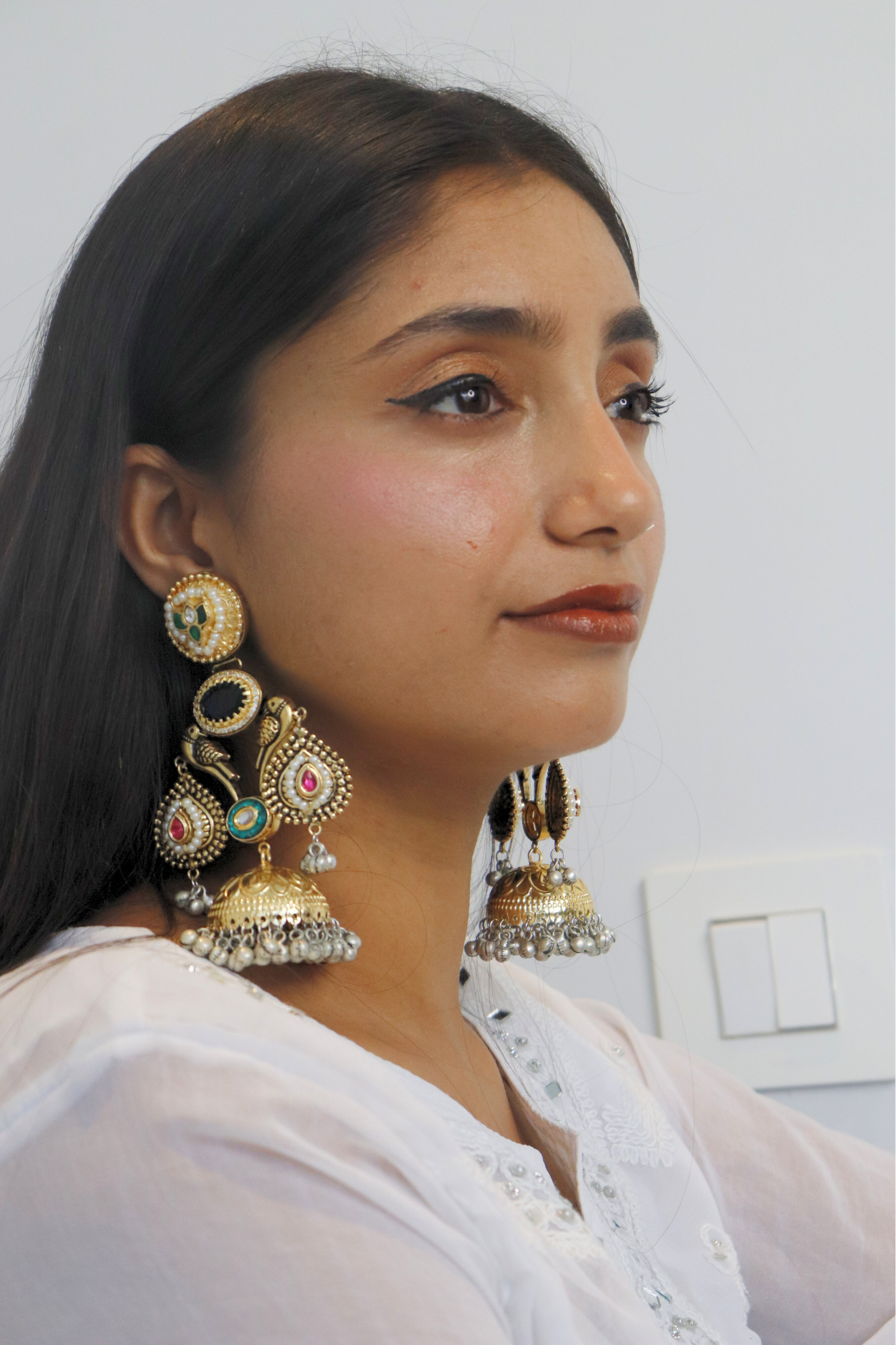 Woman wearing large, ornate earrings