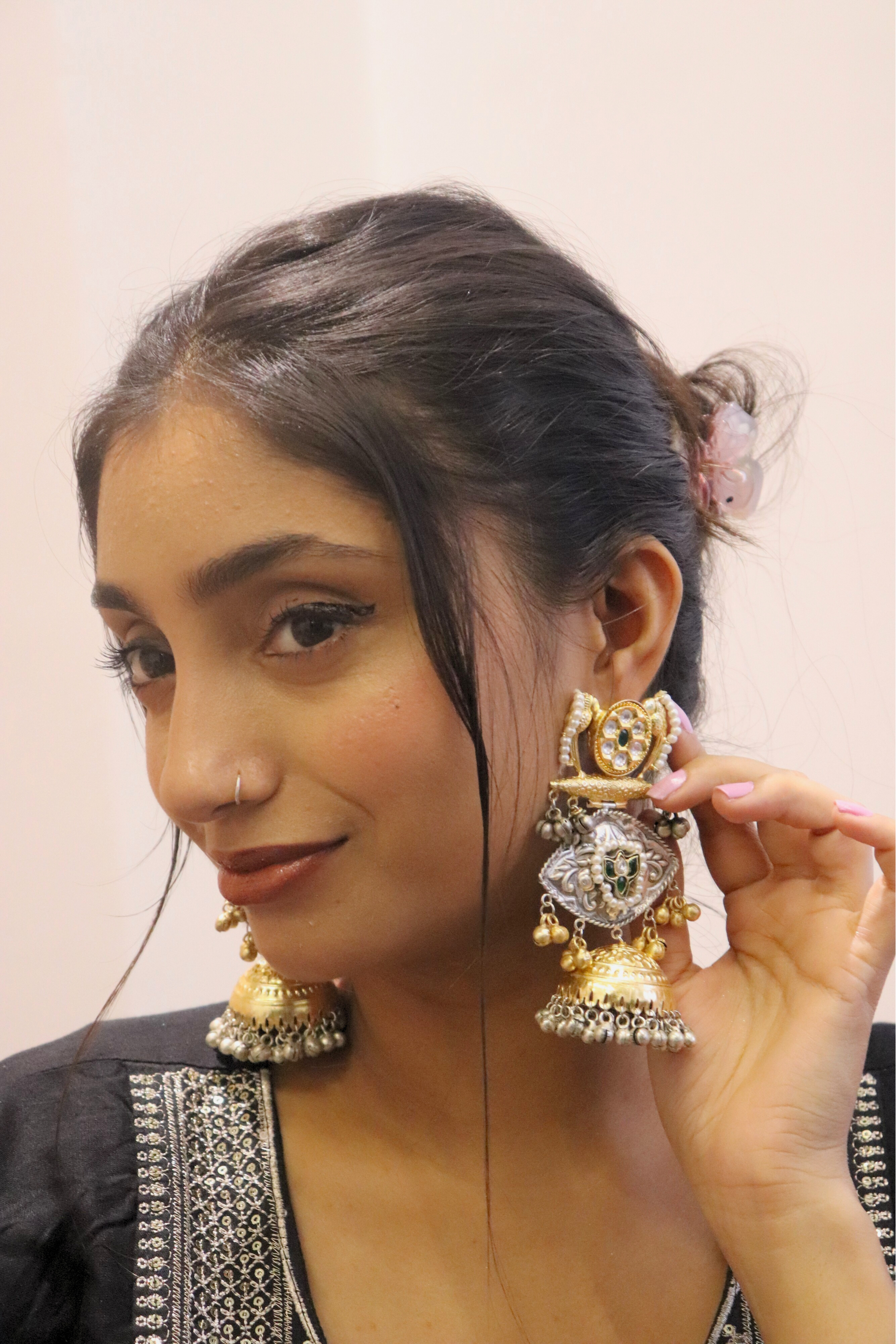 Woman wearing large, ornate earrings