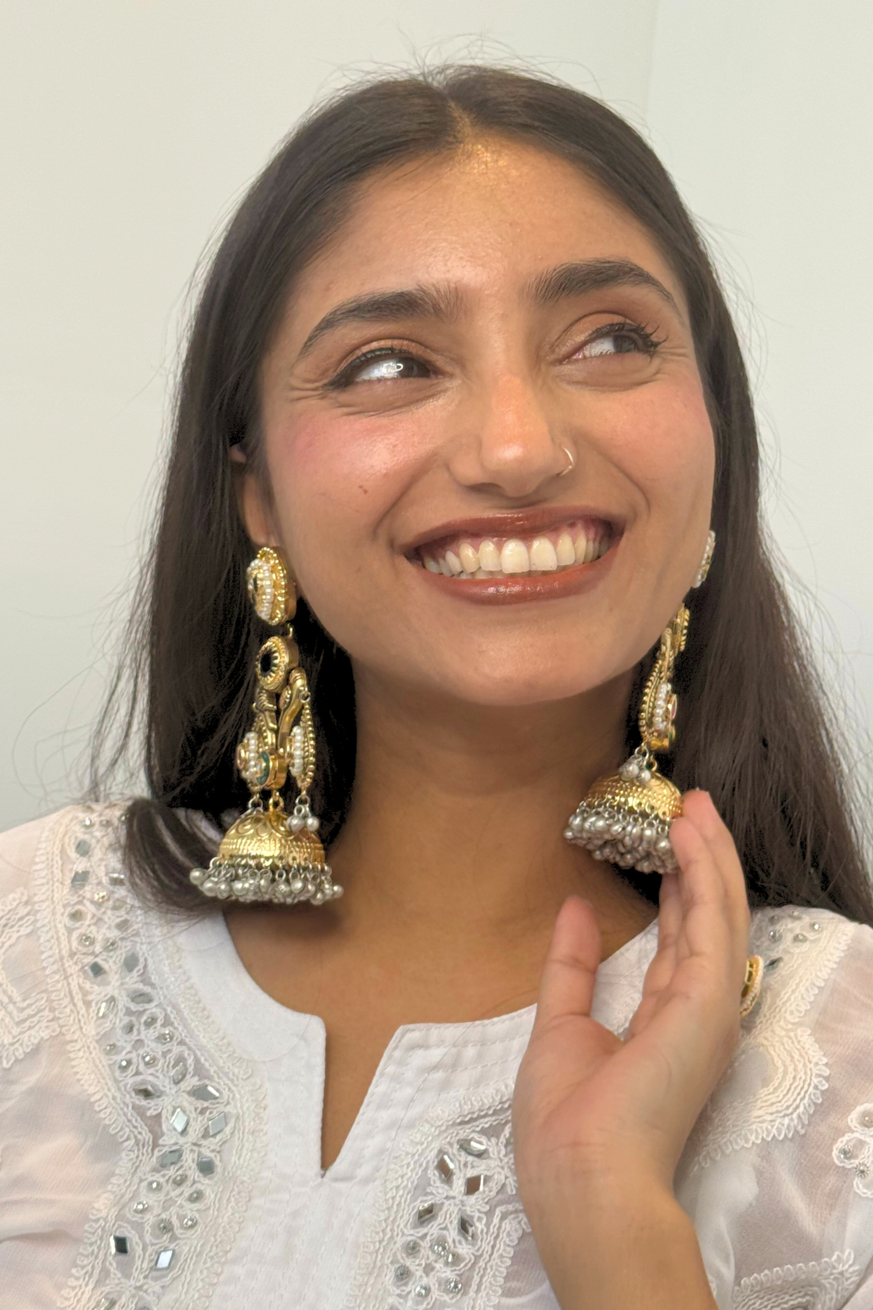 Woman wearing large, ornate earrings