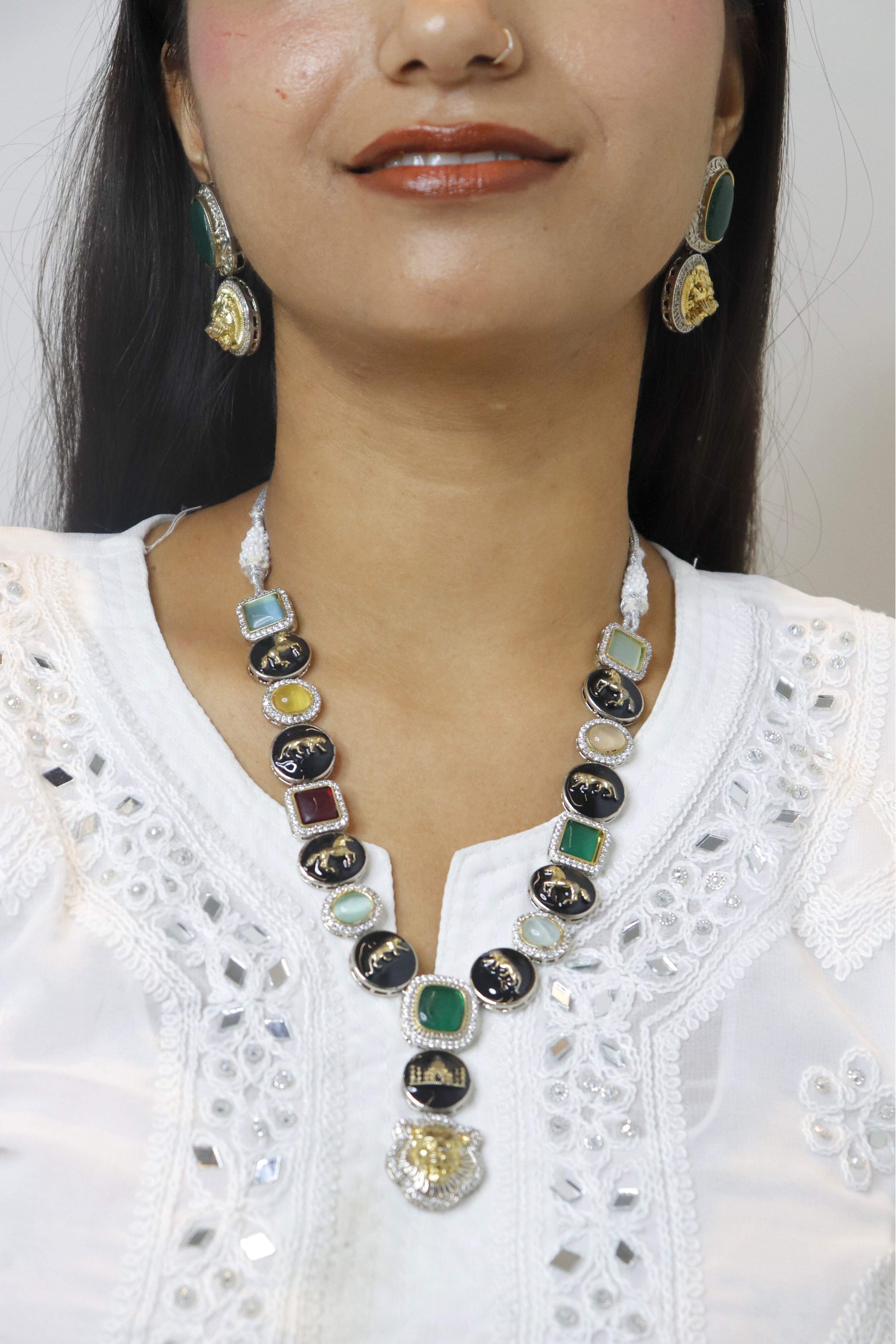 Woman wearing a colorful necklace and earrings on a white background