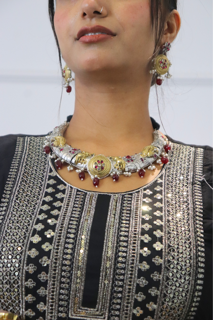 Woman wearing a detailed necklace and earrings 