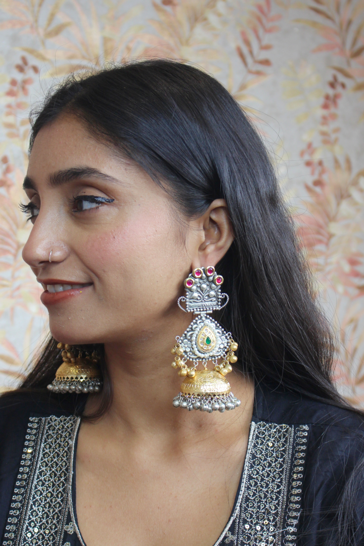 Woman wearing large, ornate earrings 