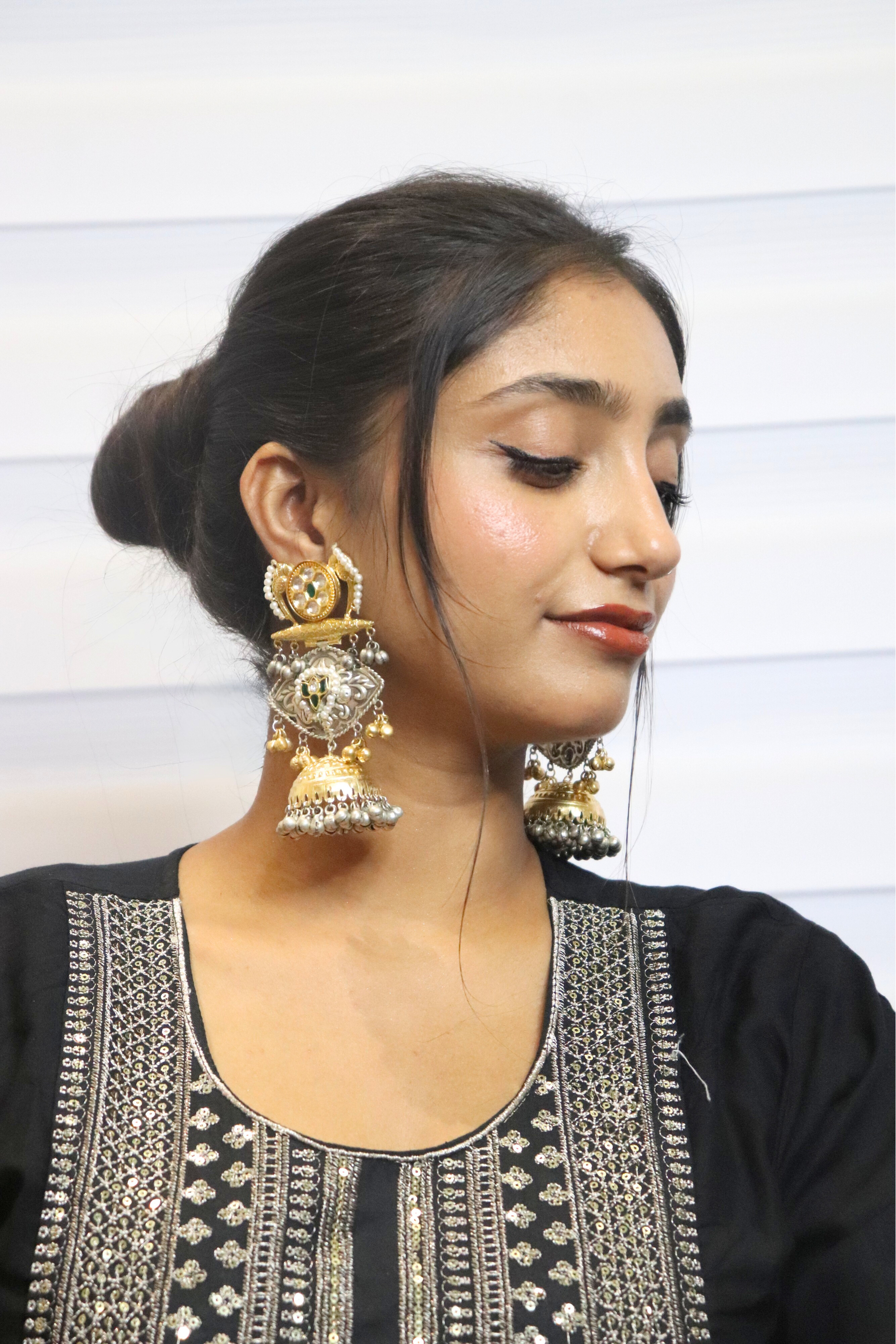 Woman wearing large gold earrings 